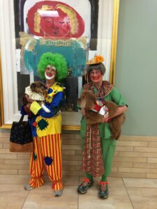 ATD members and their dogs dress up as clowns.