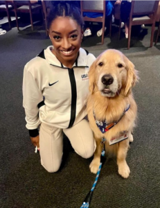 Simone Biles poses with Beacon the Therapy Dog